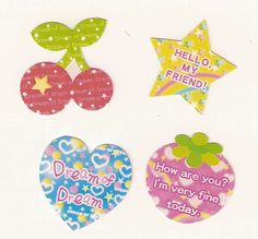 four heart shaped magnets with words on them