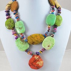 a necklace with several different colored stones on it