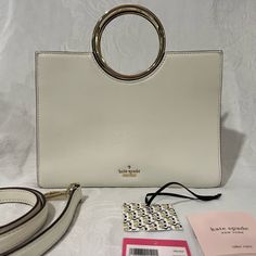 Kate Spade 25th Birthday Edition White Leather Rock Road “Sam” Handbag With Gold Handles And Detachable Shoulder Strap. Black And White Striped Lining With 4 Interior Pockets - 2 That Zip. Original Tags, Care Instructions And Dust Bag Included. Please Message Me With Any Questions. #Katespade #Birthday #Leather #Gold #Designer #Handbag Modern White Bag With Round Handle, Trendy Kate Spade Bag With Double Handle, White Satchel With Detachable Strap And Round Handle, Designer White Bag With Round Handle, Trendy Kate Spade Bag, Everyday White Satchel With Round Handle, White Tote Bag With Handle Drop, Trendy White Kate Spade Bag, Trendy Kate Spade Top Handle Bag