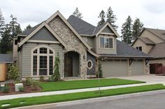 a large house with lots of windows and grass