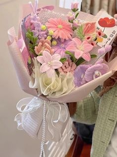 a woman is holding a bouquet of flowers