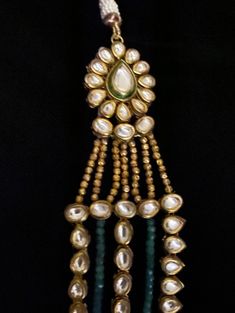 Aza Multi-String Emerald & Polki Pendant Statement Necklace Absolutely stunning Glamorous Green Emerald Gemstones and Kundan /Polki Necklace . This necklace comprises two strands of graduated lush ivory glass simulated pearls and emeralds secured by a spectacular Art Deco style push in box clasp which is encrusted with sparkly round pearl drops at the bottom of the pendant. Pair it with a choker to get the bridal look! Approximate mala length is 20". A complete synergy between traditional ae Green Pearl Drop Jewelry For Celebration, Celebration Green Jewelry With Pearl Drop, Green Pearl Jewelry For Celebration, Traditional Green Pearl Necklace For Formal Occasions, Traditional Hand-strung Jewelry For Formal Occasions, Elegant Hand-strung Pendant Jewelry, Formal Green Hand-strung Jewelry, Traditional Hand-strung Formal Jewelry, Green Pearl Drop Jewelry For Festivals