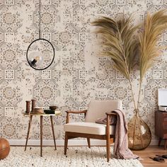 a living room with a chair, table and wallpaper