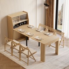 a wooden table with chairs and plates on it