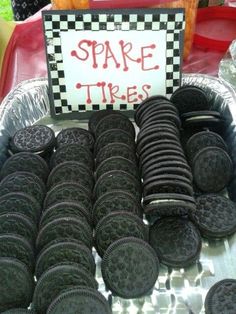 an assortment of oreo cookies are on display for sale at a market table with a sign that says spare tires