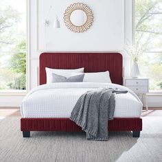 a blue bed with white sheets and pillows