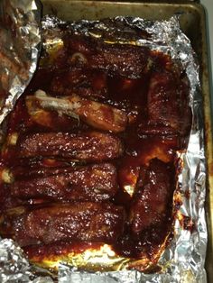 some meat is sitting on tin foil and ready to be cooked in the oven,