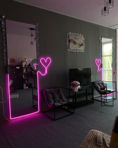 a living room filled with furniture and neon lights