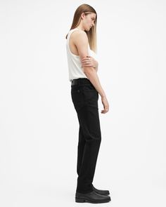 Your favorite skinny jeans, but better. Introducing the Sid – a familiar fit with refined detailing. Expertly crafted from an organic cotton blend fabric with a soft hand-feel and a little bit of stretch. They're a classic skinny fit with contemporary shaping in the waist and a workwear-inspired aesthetic. Complete with reinforced pockets and our embossed leather patch and washer. The Sid brings our signature attitude up to date with maximum comfort ensured.  In honor of our 30th anniversary, we've relaunched the AllSaints denim collection. Get to know the core staples – we've made them even better than before. These jeans are designed to be skinny fitting Button closure Mid-rise Five pocket construction Stretch denim Reinforced back pockets Interior printed pocket bags Embossed leather pa Fitted Allsaints Bottoms For Spring, Allsaints Cotton Bottoms For Spring, Allsaints Straight Leg Work Bottoms, Allsaints Relaxed Fit Straight Leg Bottoms, Allsaints Straight Leg Bottoms Relaxed Fit, Allsaints Straight Leg Relaxed Fit Bottoms, Allsaints Casual Fitted Bottoms, Non-stretch Distressed Black Jeans, Urban Black Rigid Denim Jeans