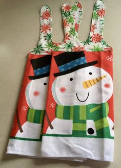 two snowmen on red and green christmas towels