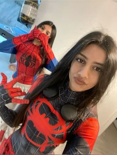 two women dressed up as spider man and woman in costume