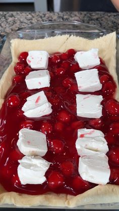 a cherry pie with marshmallows and cherries in the crust on top