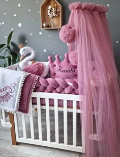 a baby's room decorated in pink and white