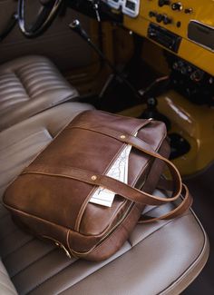 The Woodward Briefcase is the perfect companion for your daily commute. It's made of full-grain leather with solid brass hardware, which will last for years. Plus, it has a dedicated pocket for your laptop and a zipper pouch to store all your other essentials. And if you need to carry it over your shoulder, the adjustable strap makes it easy. Best of all, you can add a monogram to make it uniquely yours. All this with a lifetime guarantee to boot. Materials Features Dimensions 100% Full-Grain Le Mens Leather Satchel, Men Shoulder Bag, Smart Casual Shirts, Vintage Messenger Bag, Leather Messenger Bag Men, Laptop Bag Men, Timeless Bags, Leather Briefcase Men, Messenger Bag Men