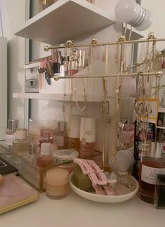 there are many items on the counter in this room, such as jewelry and candles