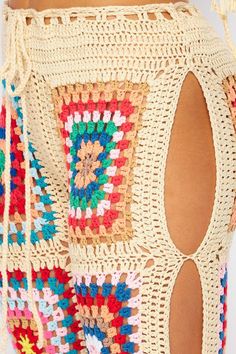 the back of a woman's shorts with crochet and beads on it