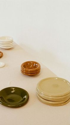 a table topped with plates and bowls on top of a white tablecloth covered floor