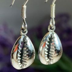 TAKE AN ADDITIONAL 20% OFF THE ALREADY REDUCED SALE PRICE - ADDITIONAL 20% IS DEDUCTED AT CHECKOUT Solid sterling silver The Goddess rises from the sea foam when a shell is tossed into the surf - this seashell symbolizes the beauty of woman and of the sea. This tiny Cowry (also spelled Cowrie) shell symbolizes the giver of life - woman and the gifts of fertility and abundance. A beautiful piece for any one who loves nature and power of a woman. 1/2" x 1/4" earrings in solid sterling silver with 4 Earrings, Cowry Shell, The Giver, Crystal Design, Cowrie Shell, Shell Earrings, The Goddess, Sea Foam, Sale Price