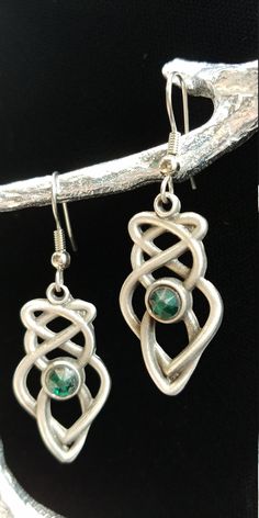 "Hand cast and hand finished out of lead-free Britannia Pewter. This pair of Celtic Knot earrings measures 1 1\\/4\" x 5\\/8\" and the earring post is surgical steel. Matching necklace is also available. I have more than one item in stock, if you require more, please contact me. History of Celtic Knots Celtic knots or Celtic interlace are ornamental patterns that first became associated with Celtic people in the early Celtic Church where they were used to decorate Bible. Monks used the Celtic kn Hand Cast Silver Dangle Earrings, Unique Hand Cast Dangle Jewelry, Silver Hand Cast Dangle Earrings, Adjustable Hand Cast Earrings As Gift, Symbolic Metal Jewelry With Matching Earrings, Hand Cast Silver Drop Earrings, Silver Hand Cast Drop Earrings, Unique Pewter Jewelry For Gifts, Silver Pewter Earrings As Gift