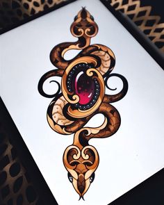 a card with an ornate design on the front and back side, depicting a snake's eye