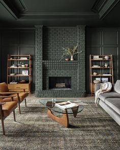 a living room filled with furniture and a fire place in front of a brick fireplace