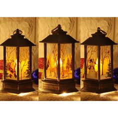 three decorative lanterns lit up with candles in the shape of deers and pine trees