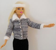 a barbie doll wearing a sweater and skirt