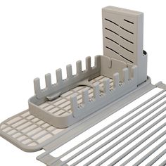 an image of a dish rack that is on the shelf for drying dishes and utensils