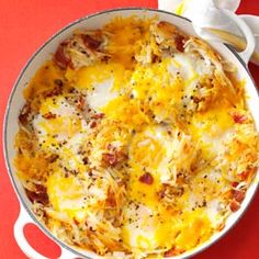 a casserole with cheese and bacon in a white dish on a red table