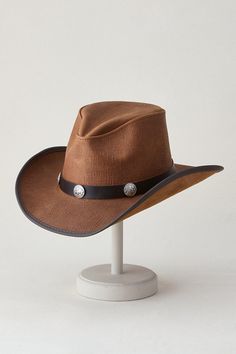 Honor the cowboy legend with the Renegade, an inimitable western-style hat handcrafted of venerable cowhide leather. Its vinyl-edged, shapeable brim allows you to create some shade or a look that suits you, and its interior sweatband assures a custom fit. Renegade's pinch-front crown is encircled by a leather hatband adorned with silver-tone buffalo conchos, keeping this classic in full character at all times. Western Brown Hat With Leather Sweatband, Western Hat With Concho And Curved Brim, Western Hat With Concho And Flat Brim, Brown Concho Hat For Rodeo, Brown Concho Hat For Western-themed Events, Country Style Brown Hat With Concho, Brown Concho Hat For Ranch, Leather Brimmed Hats For Western-themed Events, Brimmed Leather Hats For Western-themed Events