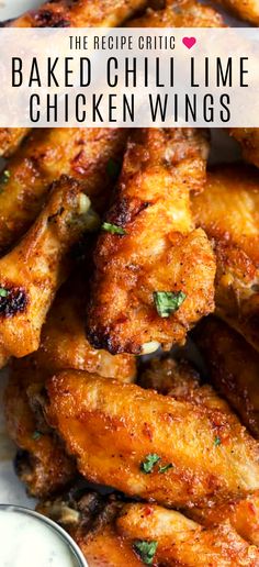 baked chilli lime chicken wings on a plate with dipping sauce and parsley in the background