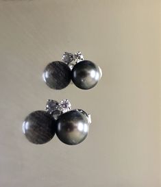 DeKara Designs Clearance Elegant Art Deco/Modern Handmade 14K White Gold Diamond and Tahitian 10 MM South Sea Black Pearl Earrings. Metal- 14K White Gold, .583. Stones- 2 Tahitian Black Pearls 10 MM, 2 Round Diamonds G-H Color VS2 Clarity 0.30 Carats. Beautifully Handmade 14K White Gold Diamond Black Pearl Stud Earrings. These earrings feature two beautiful black pearls that are carefully selected for color and luster. There are two beautiful round diamonds that are prong set on top of the pearl Luxury Black Pearl Earrings Gift, Luxury Black Pearl Earrings For Gift, Classic Black Tahitian Pearl Earrings, Elegant Black Tahitian Pearl Earrings, Formal Black Tahitian Pearl Earrings, Black Tahitian Pearl Earrings For Gifts, Luxury Black Tahitian Pearl Earrings, Pearl Diamond Earrings, Black Pearl Earrings