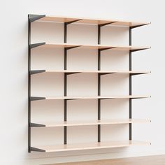 an empty book shelf against a white wall