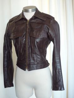 "right out of my incredible vintage closet...it is time for some other petite woman out there to enjoy this outrageous authentic harley davidson chocolate brown jacket..women's size 34 ..excellent vintage condition...obviously well cared for..measures: laying flat, 22\" pit to pit, 23\" shoulder seam to cuff, 15\" shoulder seam measured across the back, 22.5\" long and a 32\" waist..please measure yourself and compare measurements..no returns on sizing..best fits size 2 or 4 women's ..fantastic Fitted Distressed Brown Outerwear, Vintage Brown Fitted Leather Jacket For Fall, Fitted Vintage Brown Leather Jacket For Fall, Fall Fitted Vintage Brown Leather Jacket, Fitted Distressed Brown Biker Jacket, Fitted Vintage Brown Outerwear For Fall, Fitted Retro Vintage Brown Leather Jacket, Fitted Retro Vintage Brown Outerwear, Fitted Vintage Brown Retro Leather Jacket