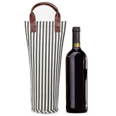 a bottle of wine next to a striped bag