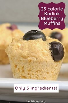 two blueberry muffins on a plate with the text 25 calorie kodak blueberry muffins only 3 ingredients