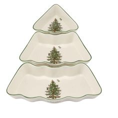 three serving dishes with christmas trees on the bottom and green trimmings, each holding a