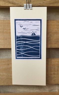 a blue and white print hanging on a wooden wall