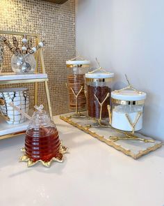 honey and other condiments sit on gold trays