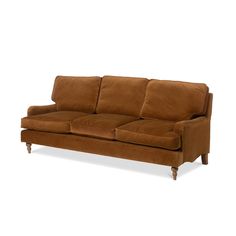 a brown couch sitting on top of a white floor