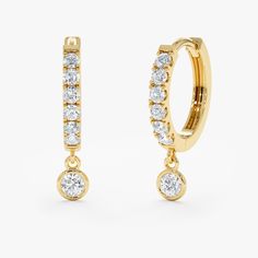 A modern twist on the classic huggie. Elevate your style with our Diamond Drop Hoop Huggie Earrings. Crafted from solid gold, these earrings feature a stunning design with lined natural diamonds, adding a touch of elegance to any ensemble. Perfect for adding a touch of sparkle to your everyday look or for a special occasion, these earrings are a must-have addition to your jewelry collection. - Handmade - Solid Gold - Natural Diamonds - Total Diamond Carat Weight: 0.26 ctw - Diameters: Outer 11 m Formal Huggie Earrings With Halo Design, Formal Halo Huggie Earrings, Huggie Earrings With Lever Back For Wedding, Yellow Gold Dangle Huggie Earrings For Anniversary, Anniversary Halo Huggie Earrings, Diamond Huggies, Beautiful Gift Wrapping, Bezel Set Diamond, Diamond Charm