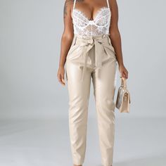 Details: Material: 55% Polyester, 45% Pu Fashion Element: Self Tie Waist Strap Closure: Front Clip On And A Zipper Closure Side Pockets Model Stats Height: 5.5" Bust:36" / Waist:28" / Hips:44" Model Is Wearing A Small Size Measurement (In) Size Waist Hips S 26-27 25-36 M 28-29 37-38 L 30-31 39-40 Elegant High Waist Leather Pants For Spring, Paperbag Waist Pants For Night Out In Spring, Chic Tapered Leg Leather Pants, Spring Chic Tapered Leg Leather Pants, Chic Spring Leather Pants With Tapered Leg, Elegant High Waist Leather Pants For Party, Chic Beige Party Pants, Spring Paperbag Waist Pants For Night Out, Elegant Paperbag Waist Bottoms