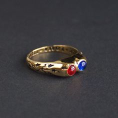 "Medieval ring with two gems and inscription \"Due tout mon coer\" (\"With all my heart\"). France or England, 15th century. Made after the artifact stored in the V&A Museum. Rings decorated with expressions of love - so called \"posy\" (from \"poesy\", poetry) rings often served as meaningful gifts to loved ones. At the same time, rings with paired gemstones were often used as engagement rings, two stones in one ring symbolized the alliance of two souls. So we can definitely say that this ring was a gift from within a loving couple. Brass cast, 24k gold plating, glass stones." Medieval Rings Engagement, Vintage Three Stone Birthstone Ring As Gift, Vintage Three Stone Birthstone Ring For Gift, Medieval Style Anniversary Ring Jewelry, Antique Three-stone Ruby Ring Gift, Antique Three Stone Ruby Ring, Antique Three Stone Ruby Ring Gift, Medieval Style Ceremonial Round Ring, Vintage Birthstone Ring With Bezel Setting As Gift