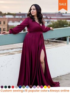 a woman in a long dress leaning against a wall with her arms on the side