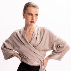 Easy and versatile, this blouse is crafted from high quality viscose fabric and has wide kimono sleeves. It is designed to wrap & tie in different ways. Wrap it around the waist and tie the straps at the front side, for a more classic look. Or cross the straps in the middle front (semi-tie, braided) and then wrap them around the waist and tie them either on the back or the front.  Pair it with its coordinating bias-cut skirt from the collection.   All pieces are cut one by one for an impeccable Silk Wrap Blouse For Evening, Silk Evening Wrap Blouse, Silk Tops With Draped Sleeves For Work, Silk Top With Draped Sleeves For Work, Chic Wrap Blouse With Tie Sleeves, Chic Silk Wrap Blouse, Elegant Workwear Wrap Top With Tie Waist, Elegant Wrap Top With Tie Waist For Work, Spring Season Formal Wrap Blouse