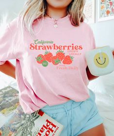 "🌟 Thank you for stopping by GirlyThreadsCo! This hand drawn coquette strawberry shirt is made to order just for you! This is the perfect tee for strawberry lovers, coquette fans,  and makes a great gift for trendy fashion lovers! 👕 PRODUCT & DESCRIPTION Our Comfort Colors 1717 t-shirts are pure comfort and garment dyed for that vintage look. Because they are unisex, they may be a bit loose on some ladies, or more fitted for some men, depending on body type and preference of fit. Our tops do have a loose fit but overall they are true to size. Please be sure to check the sizing chart to choose the right size for your preferred fit. 🚛 SHIPPING AND PRODUCTION TIME 6-9 days is needed for shipping and handling within the US. 10-30 days is needed for shipping and handling to Canada and the re Cute Strawberry Print Tops For Spring, Cute Pink T-shirt With Strawberry Print, Sweet Fruit Print Tops For Spring, Cute Fruit Print T-shirt, Cute Pink T-shirt With Cherry Print, Retro Spring Tops With Strawberry Print, Retro Spring Top With Strawberry Print, Summer Pink T-shirt With Cherry Print, Cute Cotton Tops With Fruit Design