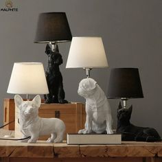 three lamps that have dogs on them and one dog is sitting next to the lamp