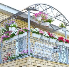 flowers are growing on the balconies above the balcony