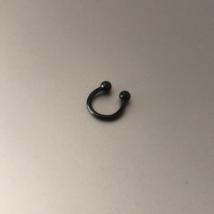 a black ring sitting on top of a table