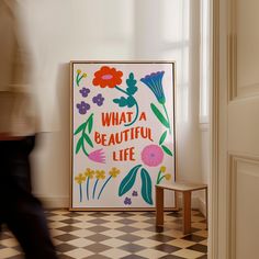 a poster with the words what a beautiful life on it in front of a checkered floor